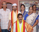 Reception Committee presents invite to Muddu Moodubelle, chairman of Kaup taluk Kannada Sahitya Samm